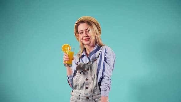 Nice Girl Holds a Red Suitcase and Drinks Orange Juice. Girl Is Flying on a Journey