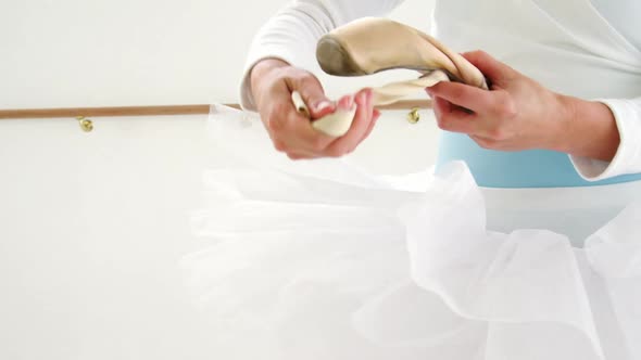 Ballerina holding ballet shoes