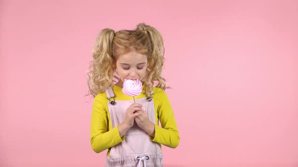 Pretty Female Child Is Eating Candy on Stick. Slow Motion