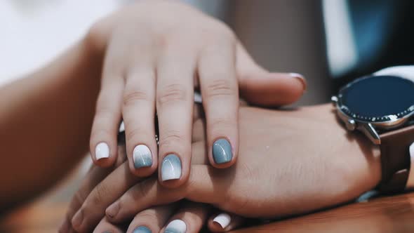 Woman with Stylish Manicure Strokes Hand of Beloved Man