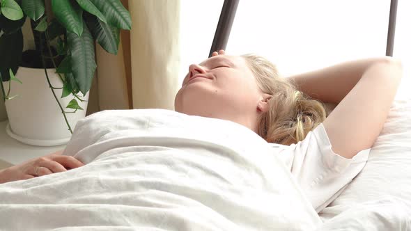 Woman Sleeping in Bedroom in the Morning