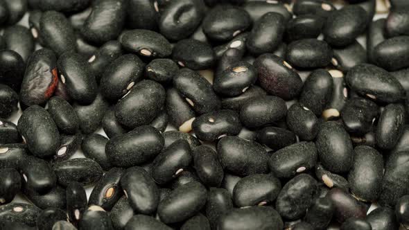 Closeup of Rotating Black Beans on Table