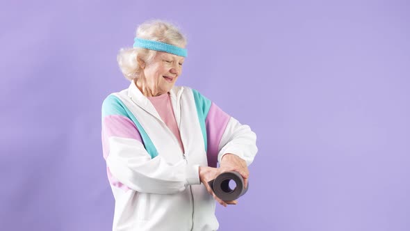 Happy Female Pensioner Holding Yoga Mat in Hands, Comes To Yoga Class in Studio