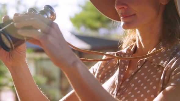 Senior woman looking through binocular 4k