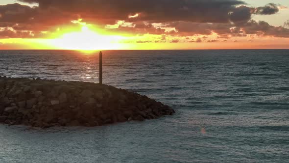 Lighthouse At Sea At Sunset