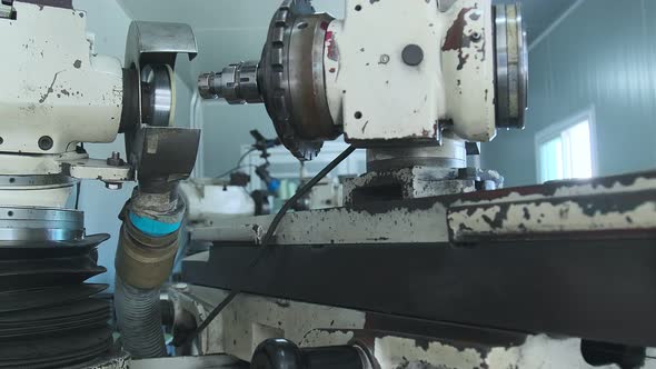 dolly shot close up of drill machine part of Metal drilling in the workshop