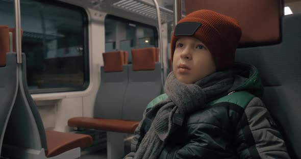 Boy Traveling By Suburban Train