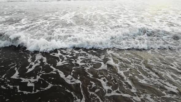 Low angle shot as waves hitting the coast in slow motion