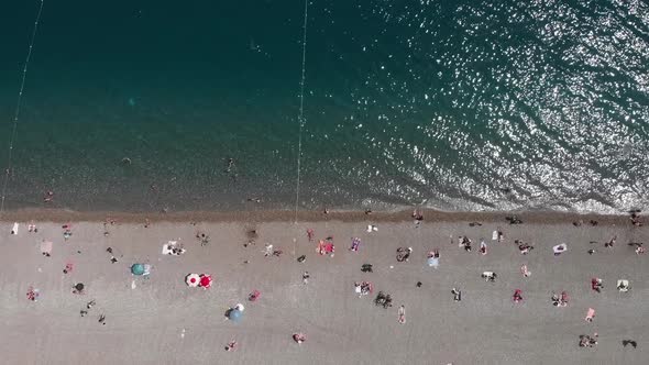 Seashore with sandy beach and turquoise sea water in Antalya, Turkey. Coastline of Mediterranean Sea