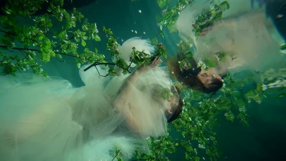 Fascinating Subaquatic Garden and Charming Fairy Woman is Floating Alone in Depth of Mysterious Sea