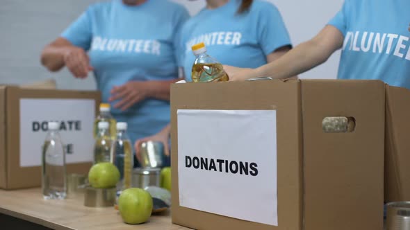 Female Activists Preparing Provision Boxes, Putting Food in Cardboard Containers