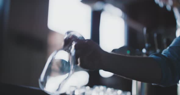 Barman crafting a beer in a urban modern bar