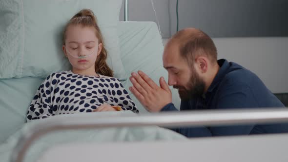 Worried Father Praying for Sick Girl Daughter Health Recovery After Suffering Medical Surgery