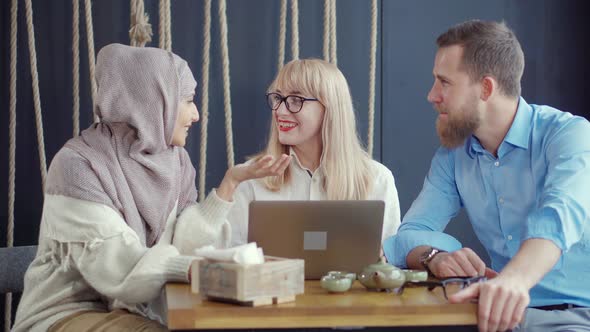 Adult Multi Ethnic Friends Are Chatting in Cafe in Daytime