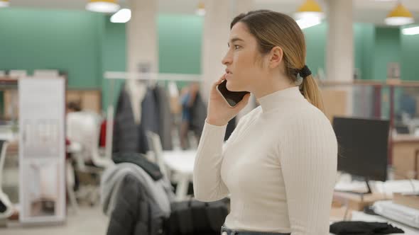 A Businesswoman Has a Conversation Using a Mobile Phone