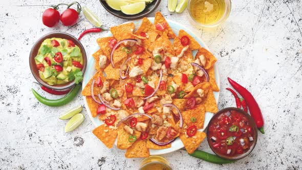 A Plate of Delicious Tortilla Nachos with Melted Cheese Sauce, Grilled Chicken