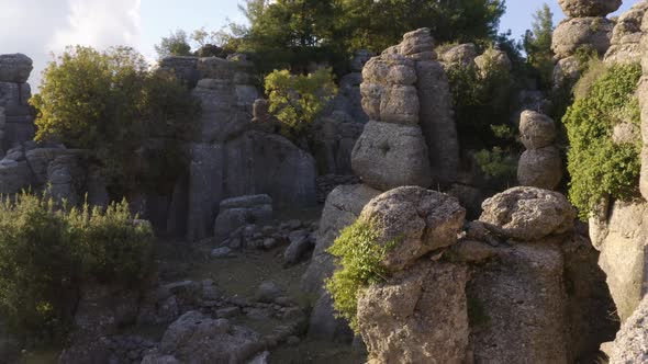 Drone View of Majestic Rock Formations with Green Plants and Coniferous Trees