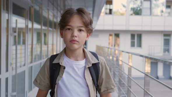 Slider Shot of Happy Teen Boy Go to School and Carry Backpack