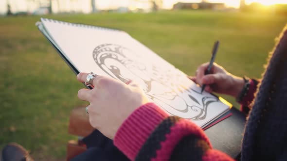 Modern Young Stylish Male Paint Artist Drawing Sketches in Park