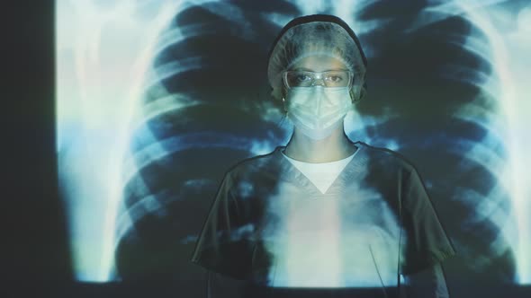 Female Doctor in Protective Uniform Posing on Chest X-Ray