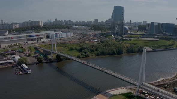 a Huge Modern White Pedestrian Bridge Across the River Against the Backdrop of the Moscow Region