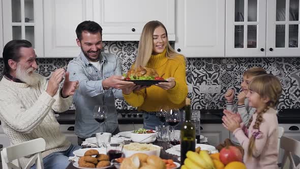 Old Grandpa and Smiling Boy and Girl Clapping in their Hands while Lovely Joyful Parents Putting