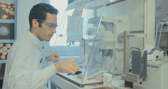 Scientist working in a pharmaceutical laboratory weighing chemicals