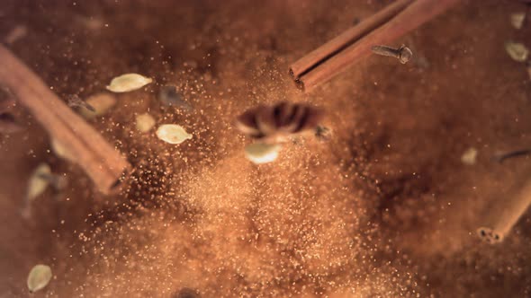 Cinnamon Sticks and Powder with Spices Flying and Falling in Slow Motion