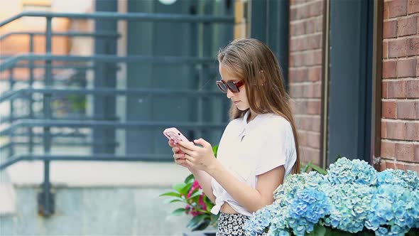 Adorable Fashion Little Girl Outdoors in European City