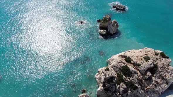 Top View of Rocks in Blue Turquoise Water. Aerial View of Calm Waves of Cyprus Mediterranean Sea on