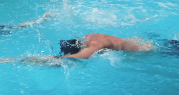 A Man and a Boy Swimming in Clear Blue Water