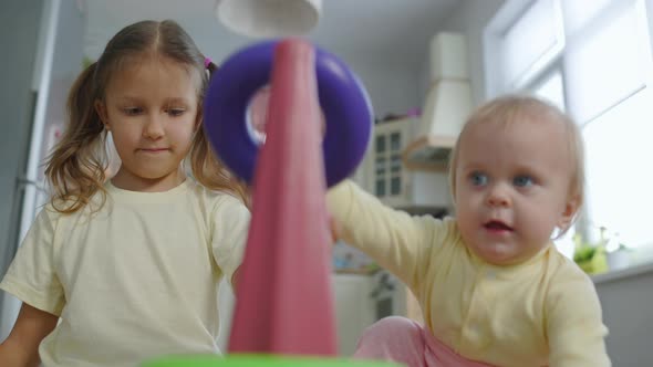 Two Sisters Girls Children Play Toys In The Room At Home