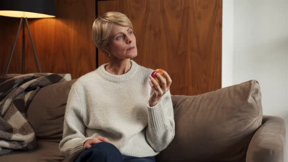 Smiling Middleaged Woman Holding a Green Apple in Her Hands Healthy Eating Concept