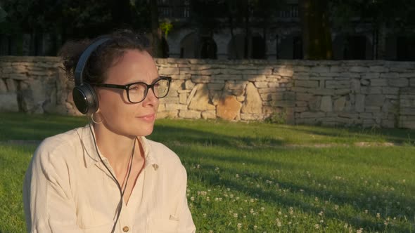 Woman in headphones at the park. 