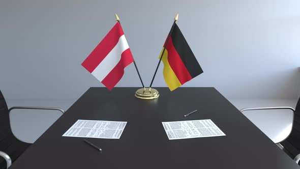 Flags of Austria and Germany and Papers on the Table