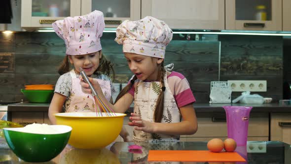 Girls mixing ingredients in a bowl