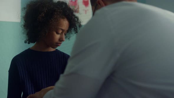 Doctor Using Tonometer Cuff on Kid Arm