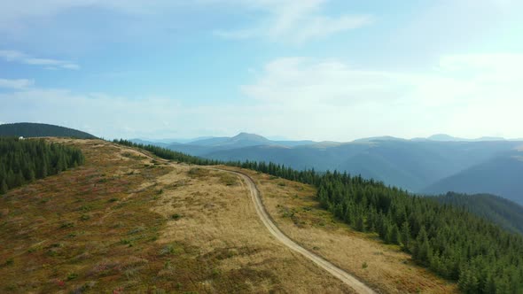 Aerial Mountain Path Scene with Stunning Rocky Pikes Background Against Sky