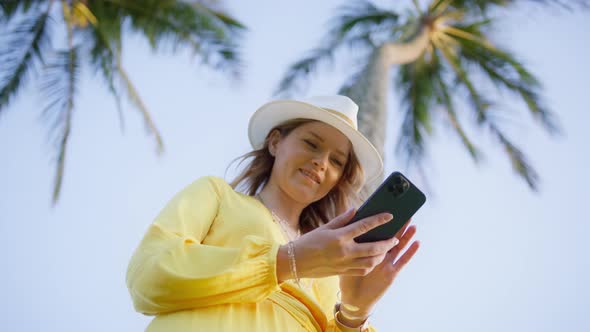 Portrait Happy Tourist Woman Enjoy Success on Mobile Phone at Working on Island