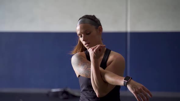 Exhausted female athlete stretching after workout