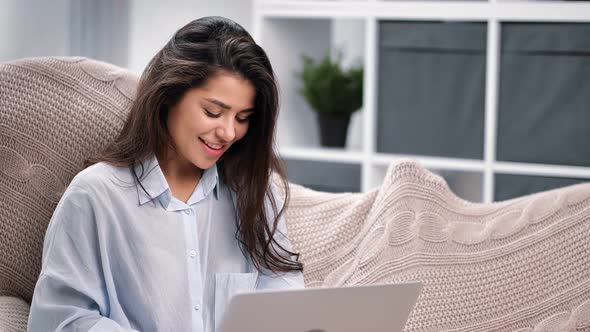 Smiling Mixed Race Woman Chatting on Laptop Pc Sitting on Couch