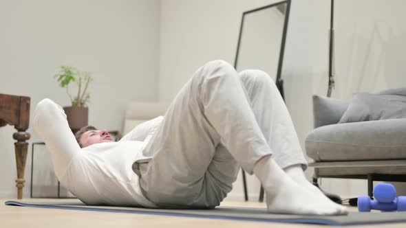 Man Doing Workout on Yoga Mat at Home