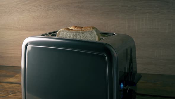 White Bread Is Put In Toaster And Pops Up