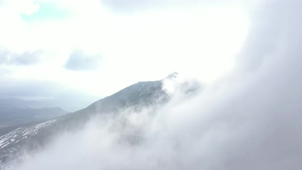 High fog covers the mountain top 4K drone video