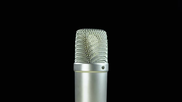 Studio Condenser Microphone Rotates on a Black Background