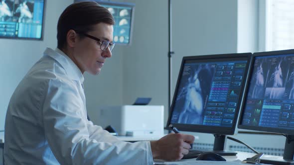 Professional medical doctors working in hospital office making computer research.