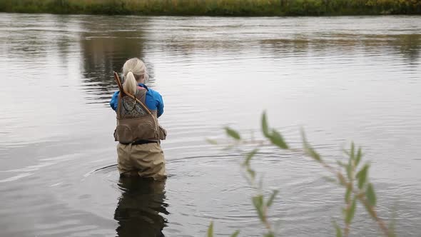 Woman Fly Fishing on Calm River