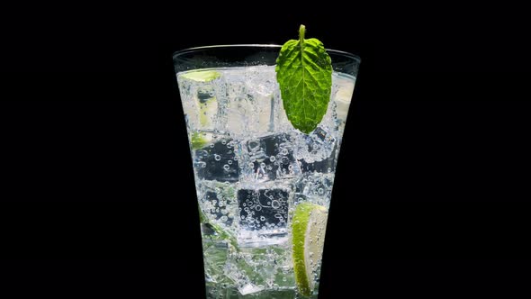 Refreshing drink with mint and lime in transparent glass 