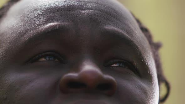 Black Lives Matter. Close Up Shot of African Man with Red Eyes Looking Up