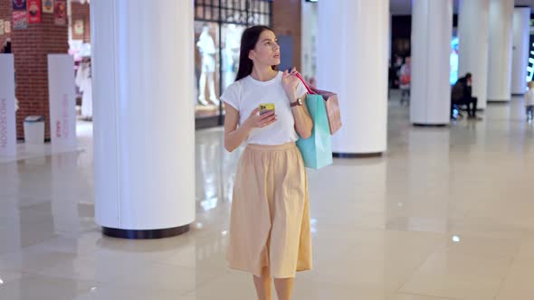 Young Female Using Navigation App on Phone to Find Store in Shopping Mall